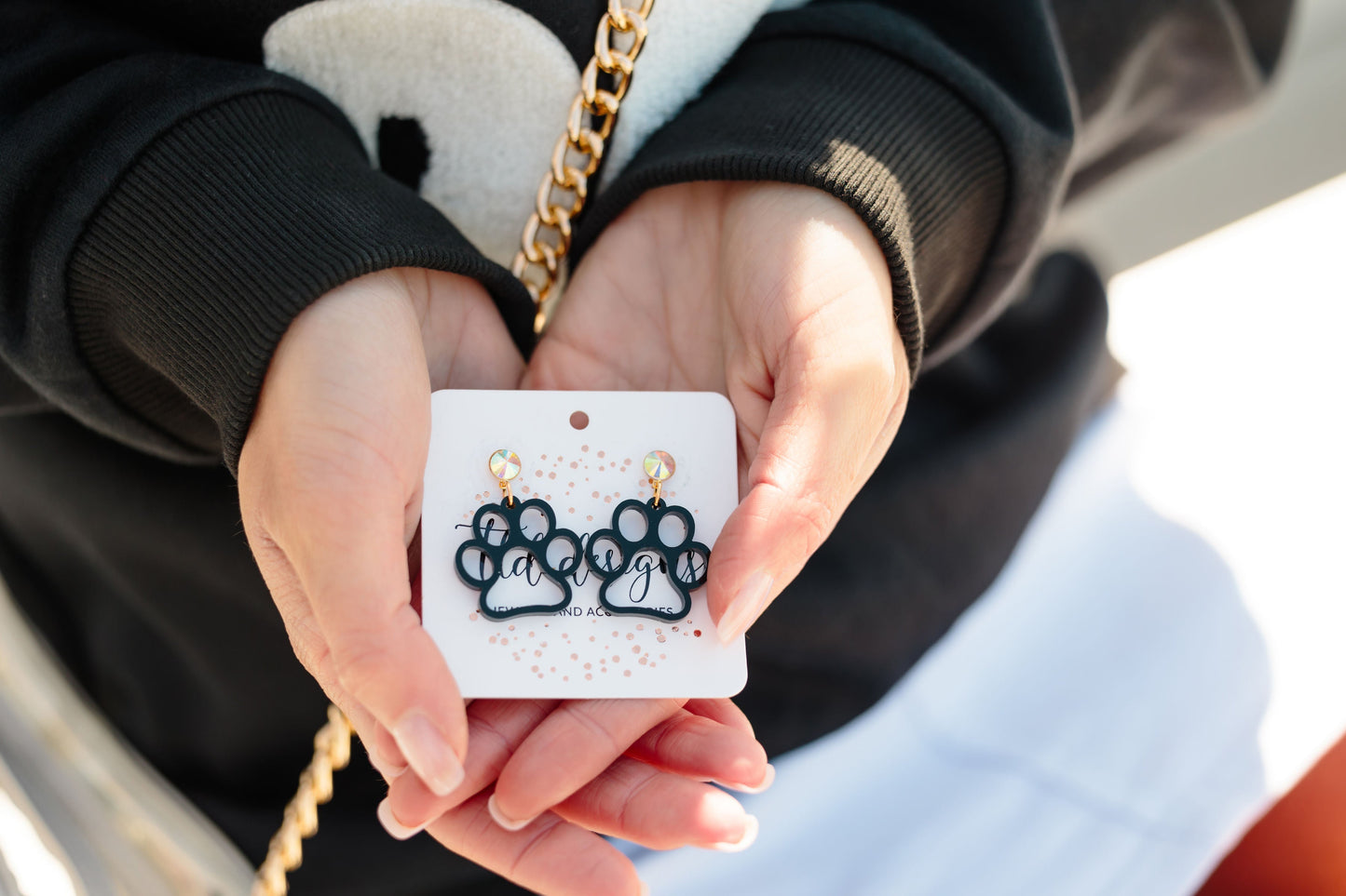 Black paw print drop earrings with iridescent posts, perfect for Royse City Bulldogs game day style.