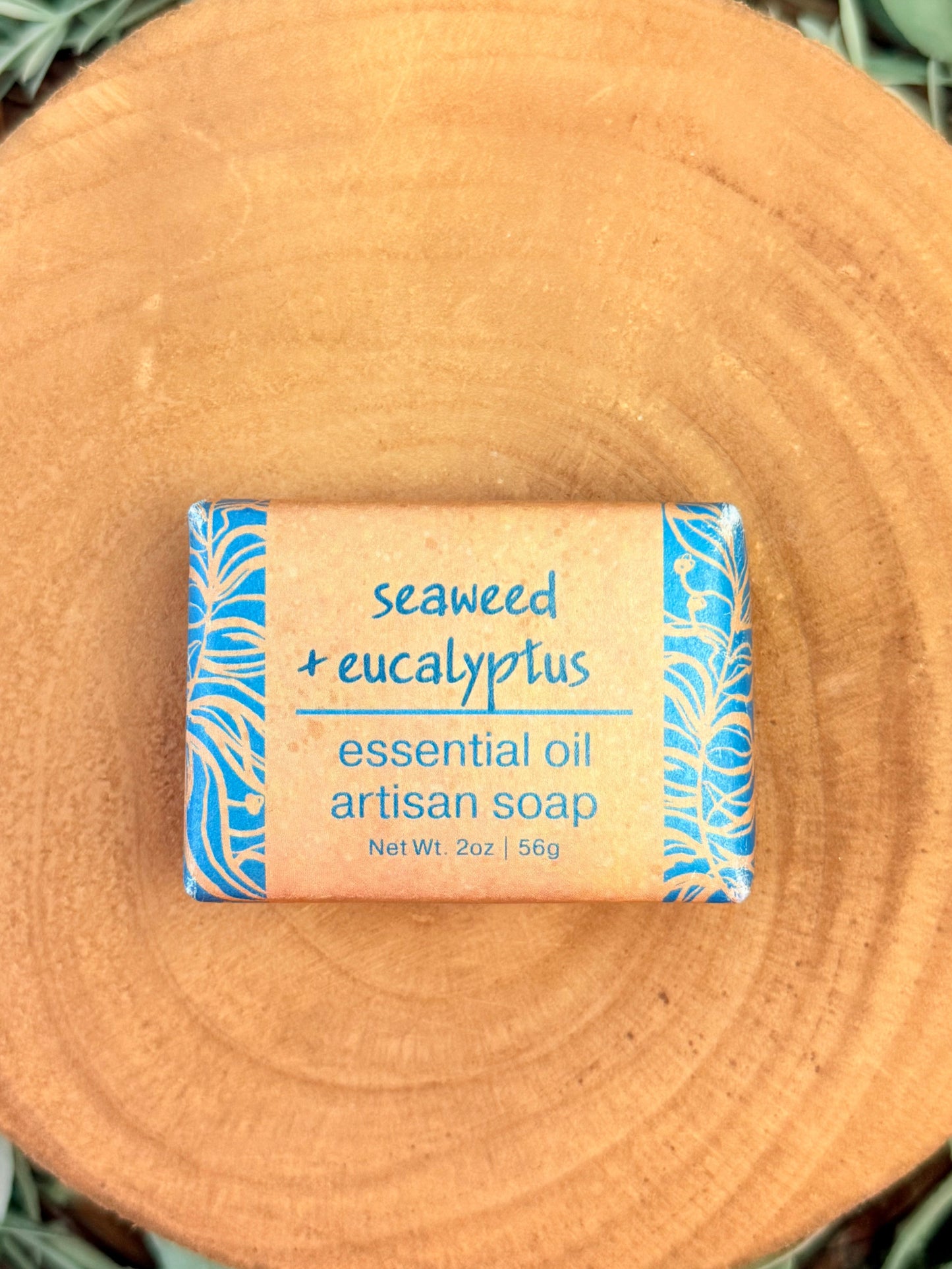 Artisan soap bar with seaweed and eucalyptus scent on a wooden surface