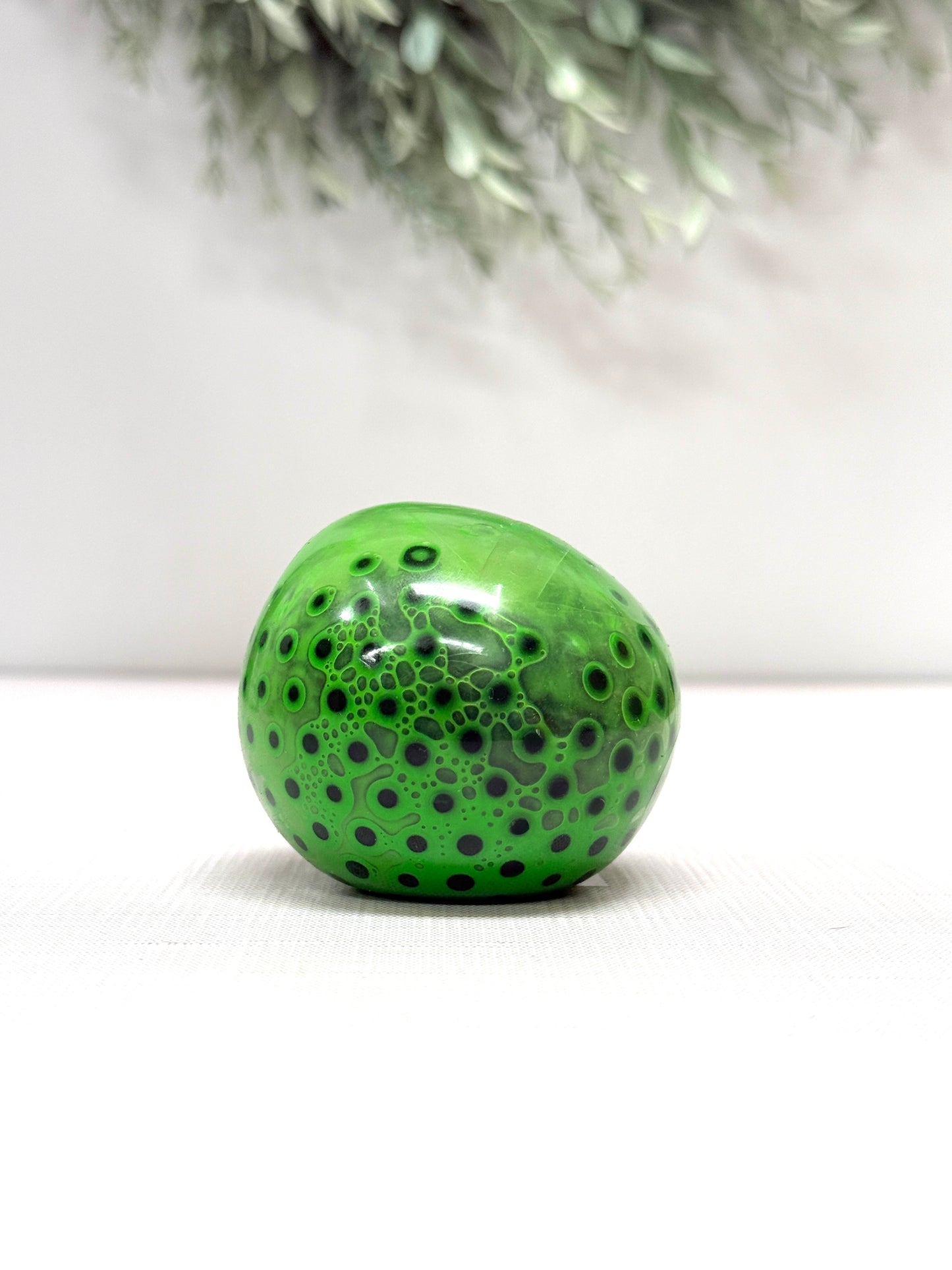 OOZE Ball sensory squeeze toy available in pink, orange, green, and yellow