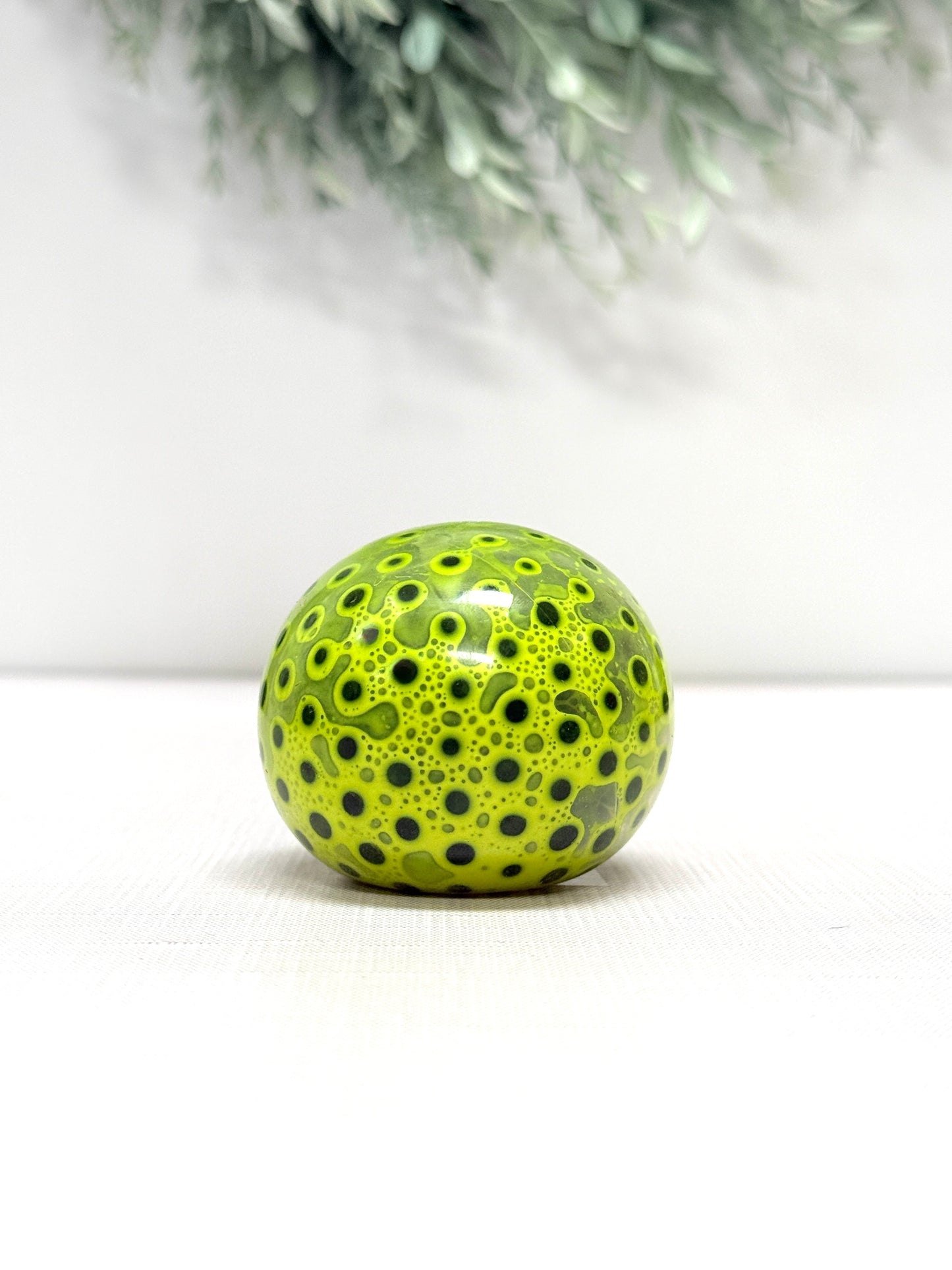 OOZE Ball sensory squeeze toy available in pink, orange, green, and yellow