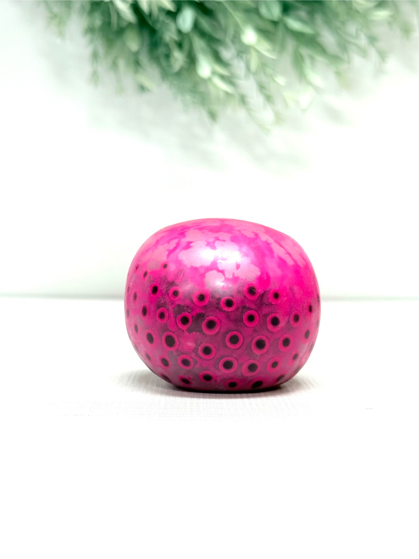 OOZE Ball sensory squeeze toy available in pink, orange, green, and yellow
