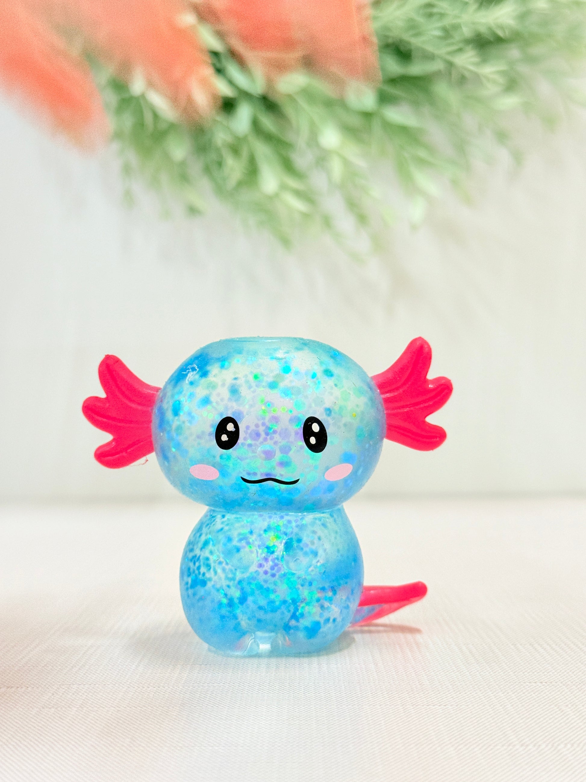 Glittery axolotl squish toy in blue sensory fidget
