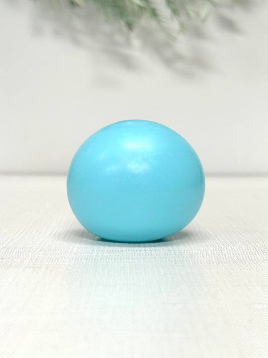 Glow in the dark gummy squish ball sensory toy available in green, blue, and yellow