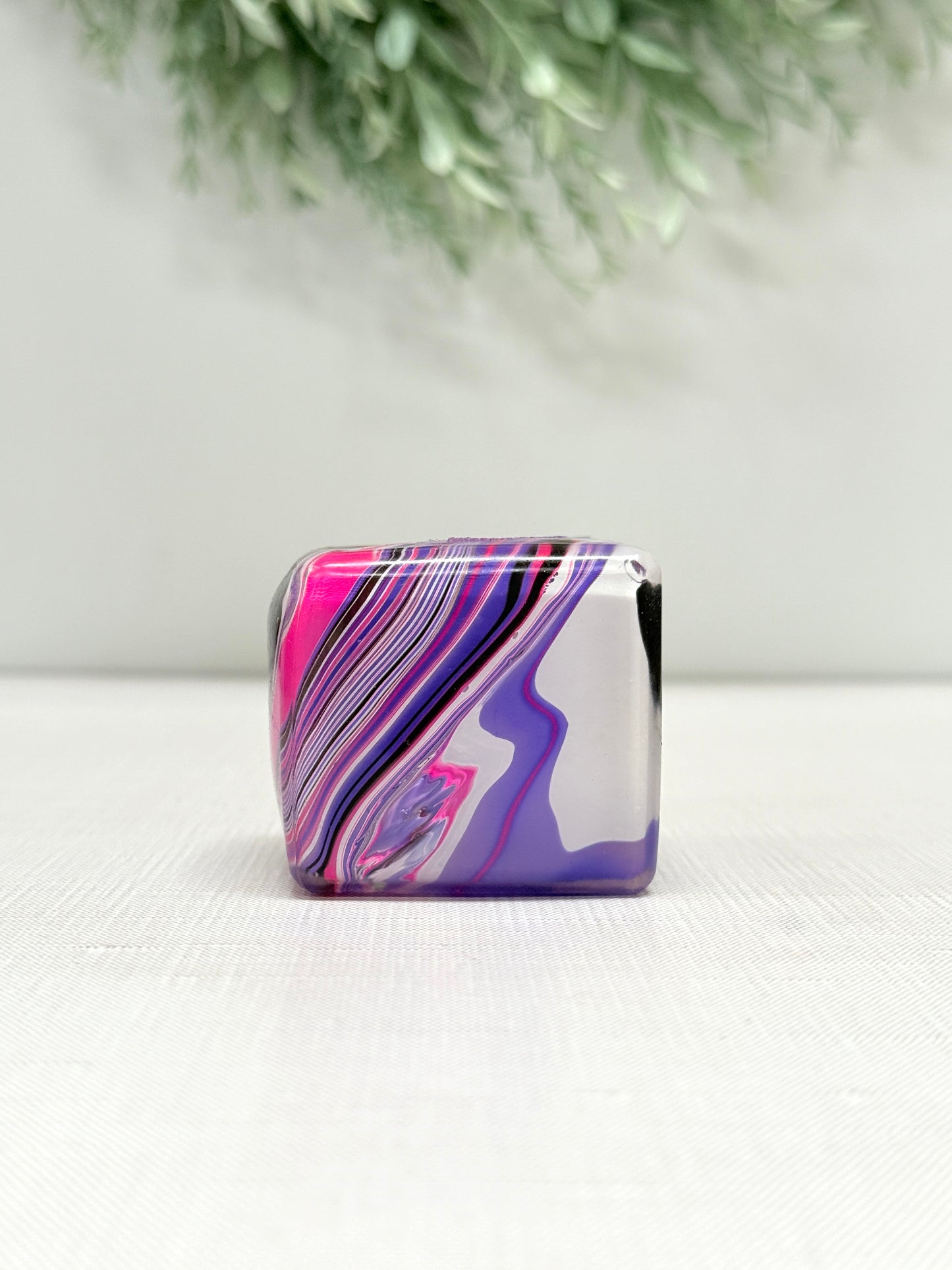 Swirl Cube Gummee Squish sensory toy with colorful swirl design in pink, purple, green, and orange