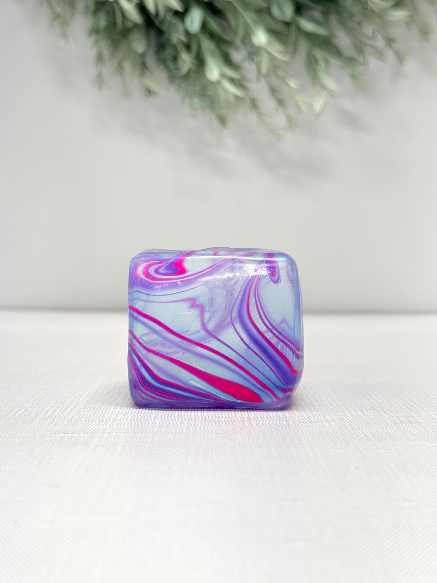 Swirl Cube Gummee Squish sensory toy with colorful swirl design in pink, purple, green, and orange